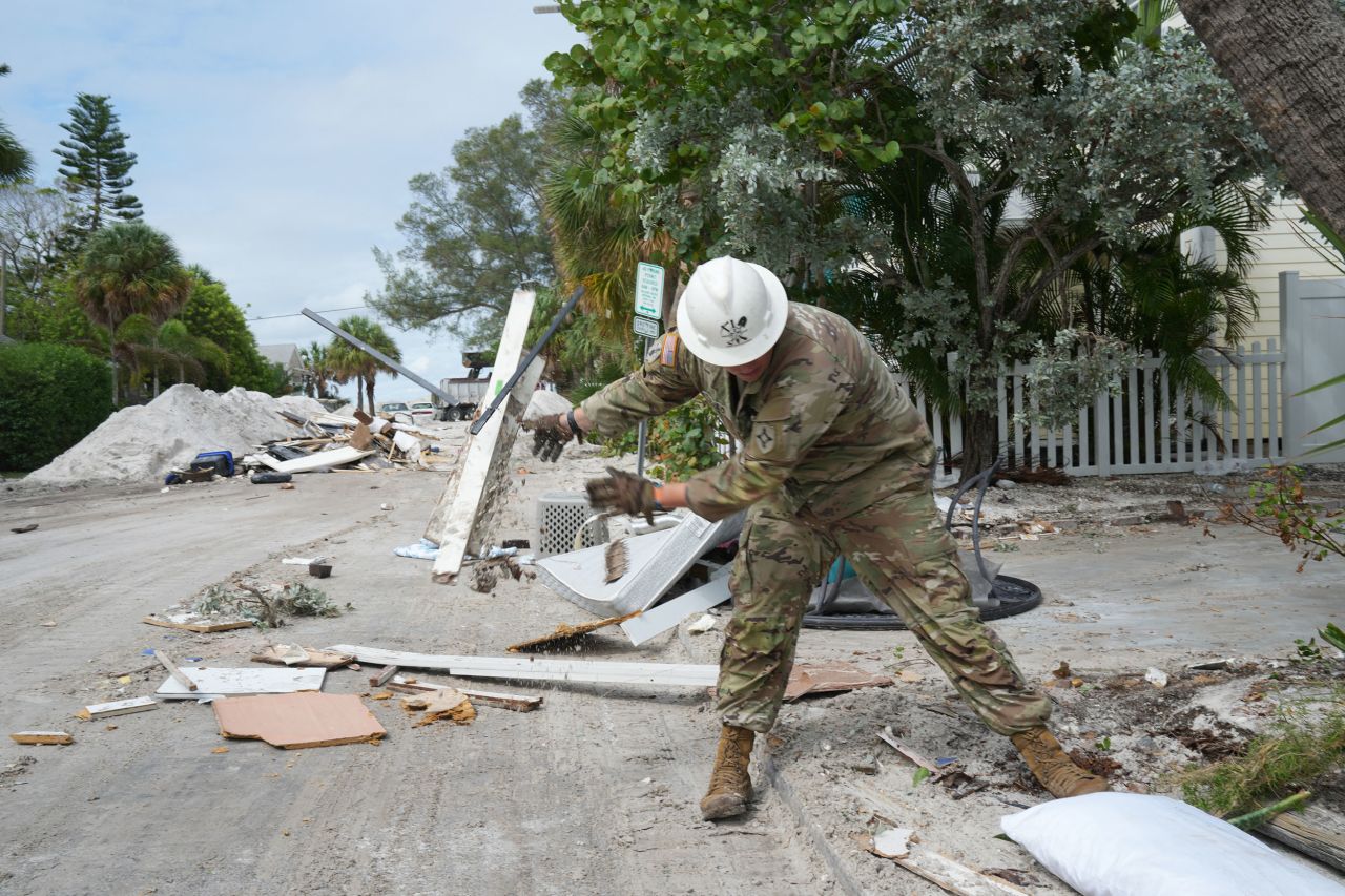 A Florida Army National Guard member works to remove debris in the Pass-A-Grille section of St. Petersburg ahead of Hurricane Milton's expected landfall in the middle of this week on October 7.