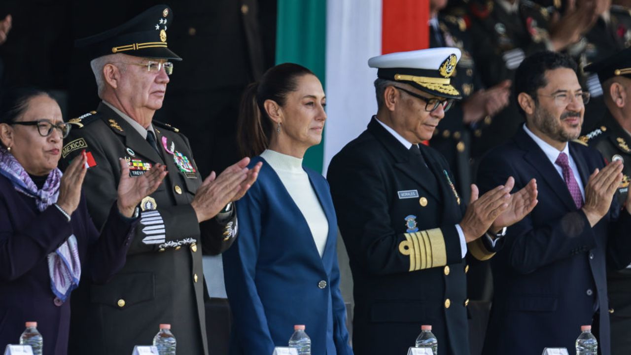 MEXICO CITY, MEXICO - OCTOBER 03: (L-R) Defense Minister of Mexico, General Ricardo Trevilla, President of Mexico Claudia Sheinbaum and Marine Minister of Mexico, Admiral Raymundo Pedro Morales, gesture during the salutations ceremony with armed forces at Campo Marte on October 03, 2024 in Mexico City, Mexico. (Photo by Manuel Velasquez/Getty Images)