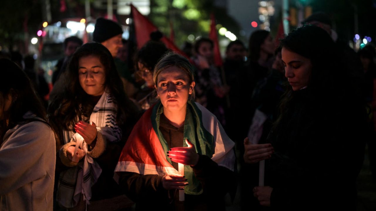 Pro-Palestine activists light candles as they take part in a vigil within the framework of the first anniversary of the Israel-Hamas conflict in Mexico City on October 7, 2024. With candles, prayers and music, commemorations for the October 7 attack began in Israel's Tel Aviv on October 6 at a ceremony to mark the first anniversary of the Hamas onslaught at the Nova music festival. The anniversary comes with Israel engaged in a fresh war in Lebanon against Hezbollah and preparing to retaliate against Tehran, raising fears of an even wider conflict. (Photo by Yuri CORTEZ / AFP) (Photo by YURI CORTEZ/AFP via Getty Images)