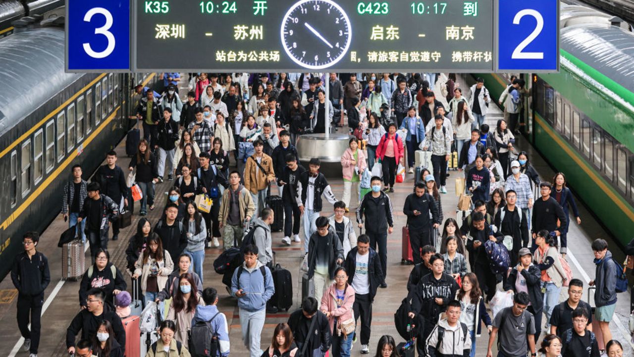 The photo taken on October 7, 2024 shows people arriving at Nanjing railway station after the National Day holidays in Nanjing, in eastern China's Jiangsu province. (Photo by STRINGER / AFP) / China OUT (Photo by STRINGER/AFP via Getty Images)