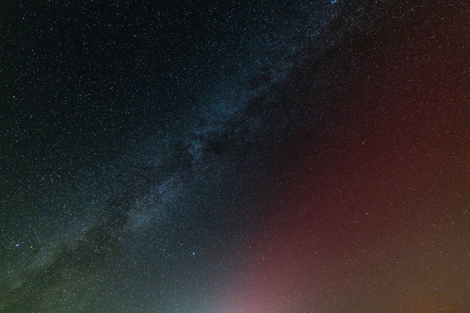 The Milky Way and northern lights are seen together as the aurora makes a rare appearance in the Eastern Sierra mountains of California in the early morning hours Tuesday.