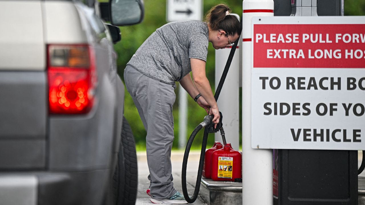 People fill up gas containers at a station in Lakeland, Florida, on October 8.