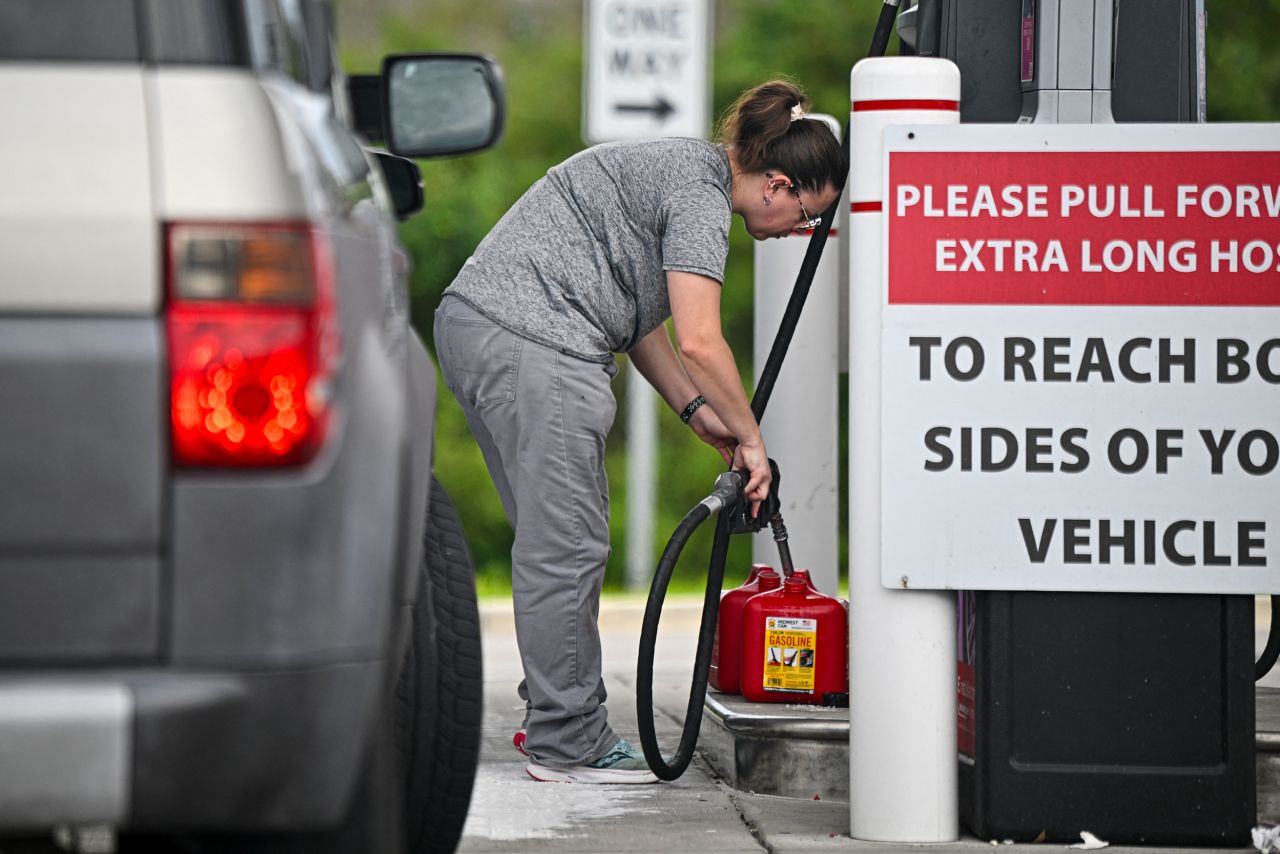 People fill up gas containers at a station ahead of Hurricane Milton's expected landfall in Lakeland, Florida on October 8.