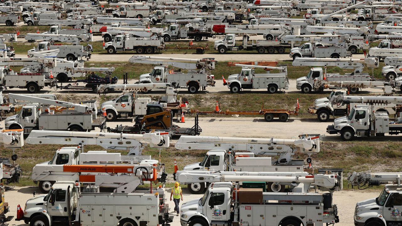 Hundreds of lineman trucks are staged at The Villages, Florida, on October 8.