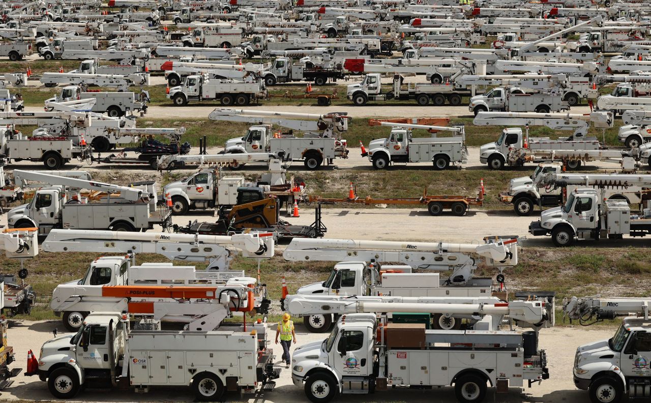 Hundreds of lineman trucks are staged at The Villages, Florida, on October 8.