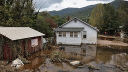 SWANNANOA, NORTH CAROLINA - OCTOBER 04: An American flag hangs above floodwaters remaining from Hurricane Helene on October 4, 2024 in Swannanoa, North Carolina. At least 215 people were killed in six states in the wake of the powerful hurricane which made landfall as a Category 4. President Joe Biden ordered the deployment of 1,000 active duty U.S. soldiers to assist with storm relief efforts in what is now the deadliest U.S. mainland hurricane since Hurricane Katrina. (Photo by Mario Tama/Getty Images)