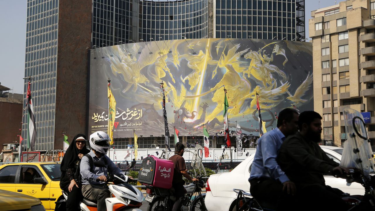 A banner reading "The roar of the lions will be your funeral" in Hebrew, Persian and English is hung on a building on Veliasr Square in Tehran, Iran, on October 8.