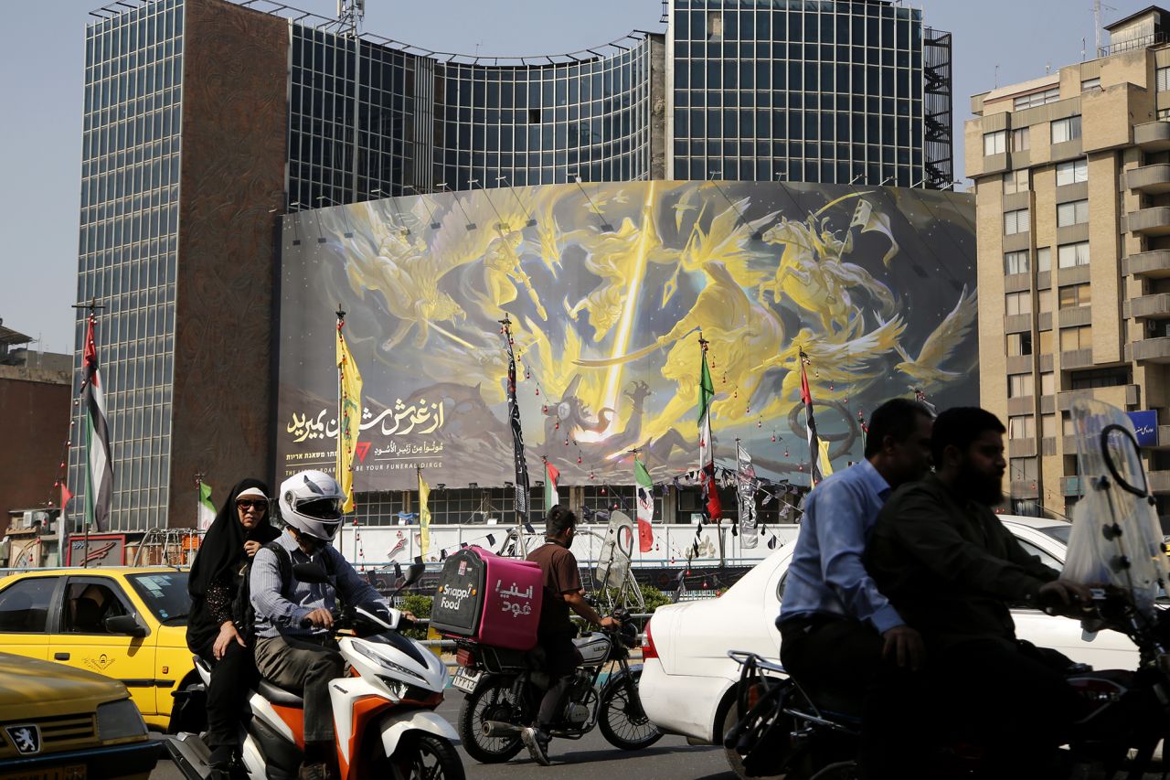 A banner reading "The roar of the lions will be your funeral" in Hebrew, Persian and English is hung on a building on Veliasr Square in Tehran, Iran, on October 8.