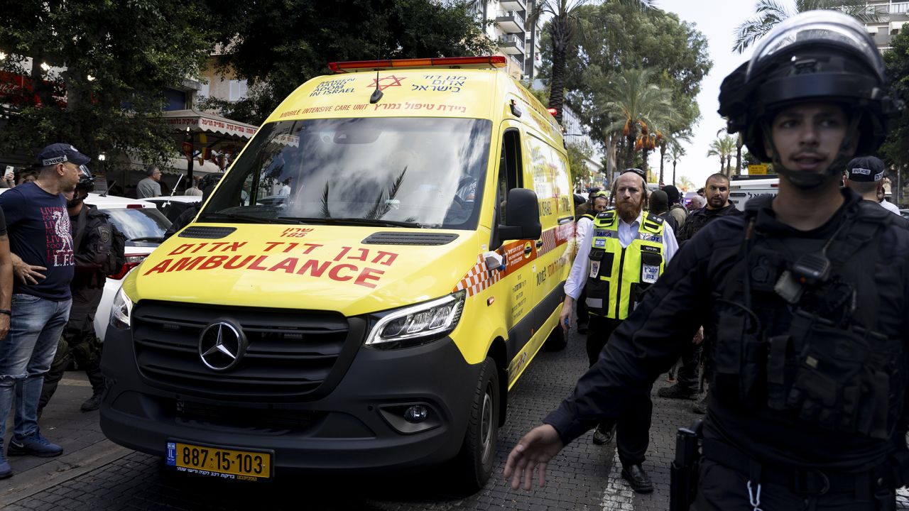 Israeli police officers surround an ambulance transporting an injured man after a stabbing attack on October 9, in Hadera, Israel.