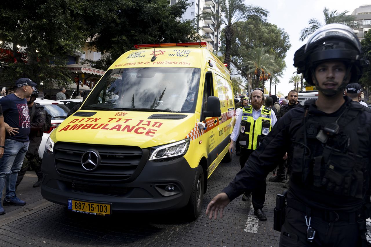 Israeli police officers surround an ambulance transporting an injured man after a stabbing attack on October 9, in Hadera, Israel.