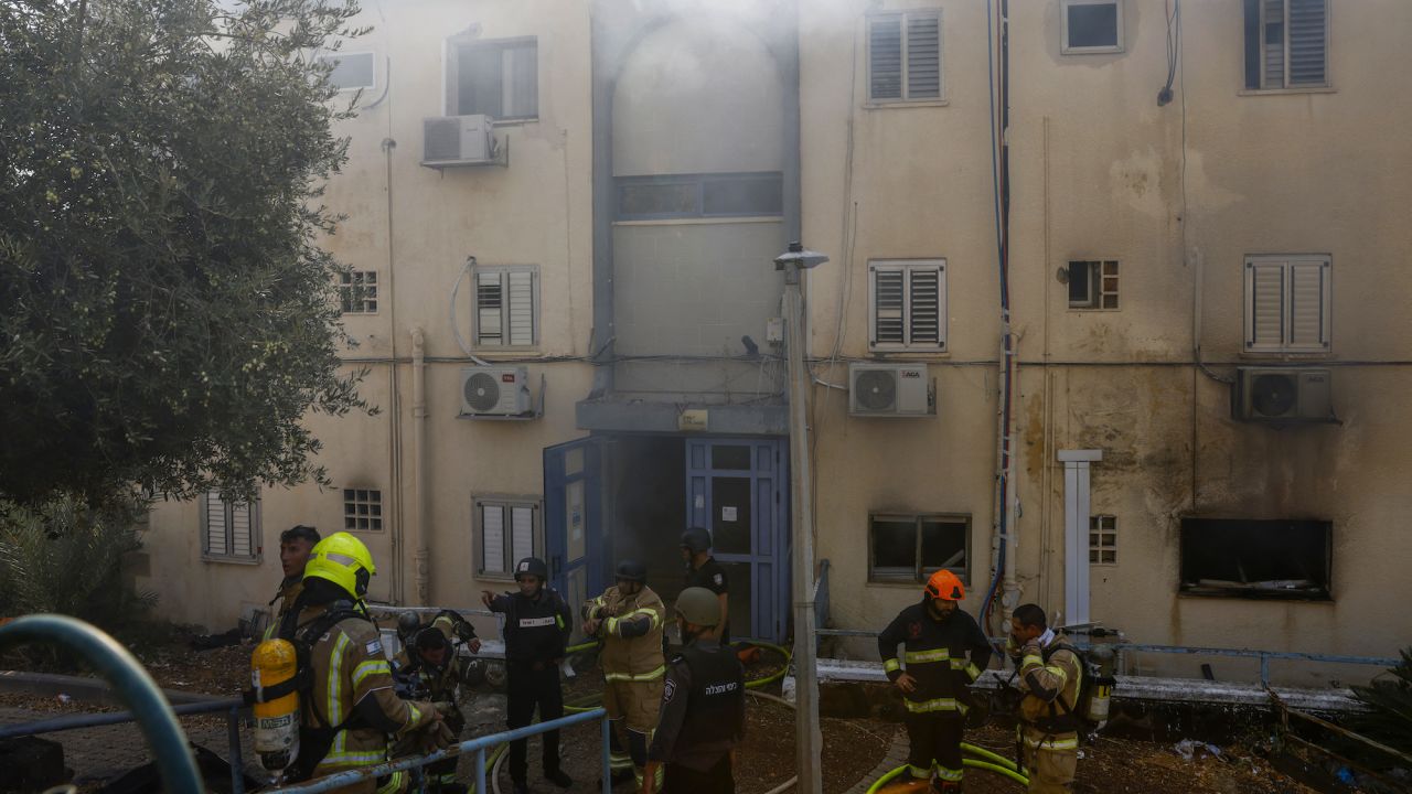 Emergency personnel are seen at a site hit by rockets fired from Lebanon in the northern Israeli city of Kiryat Shmona near the Lebanese border on Wednesday.