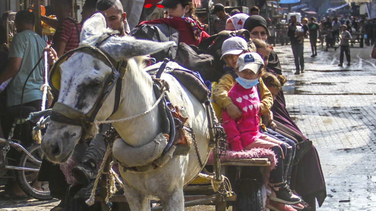 Palestinian residents of the Jabalya Refugee Camp flee to other areas, with the belongings they could carry, following Israeli attacks on the camp in Gaza City, Gaza on October 1, 2024.