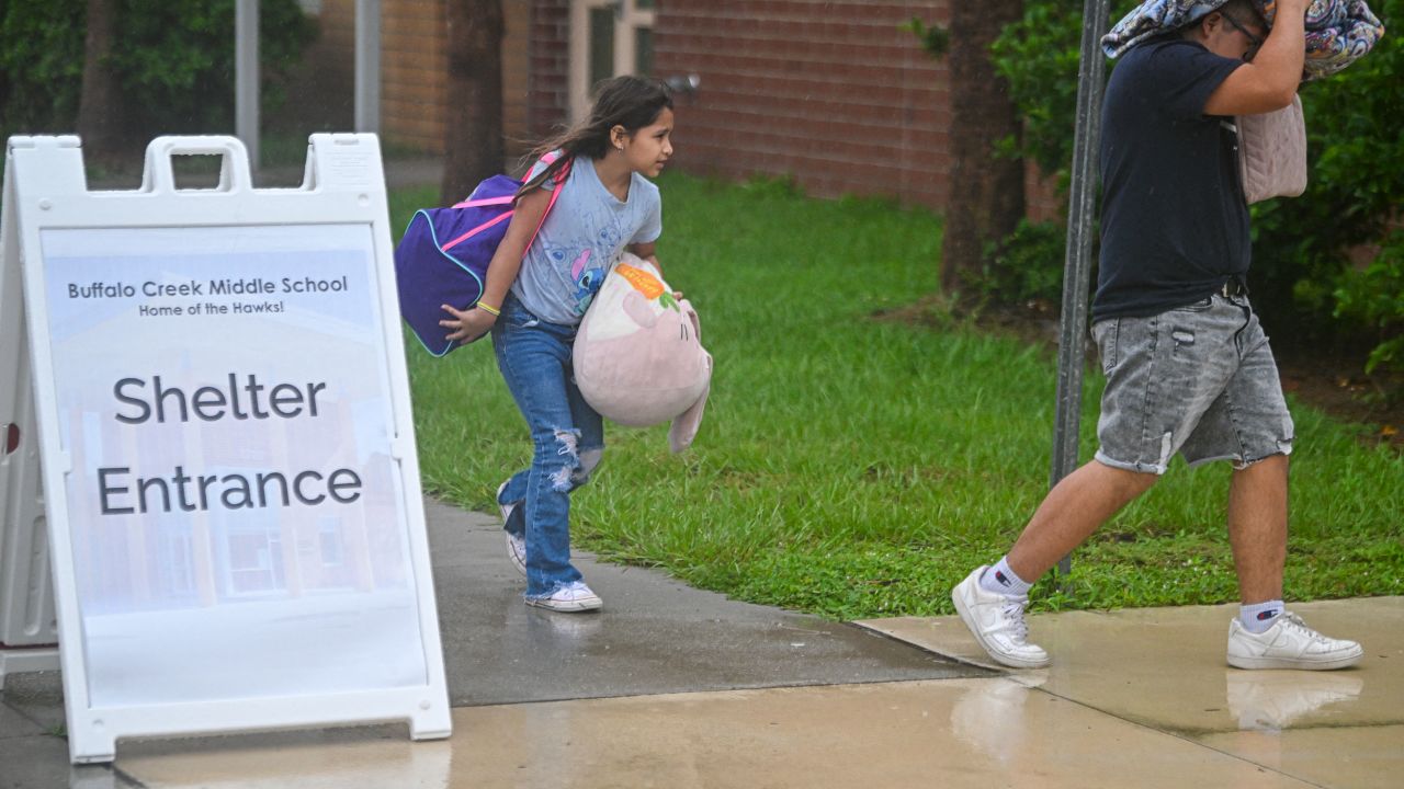 People arrive at a shelter at Buffalo Creek Middle School in Bradenton, Florida, ahead of Hurricane Milton's expected landfall on October 9, 2024.