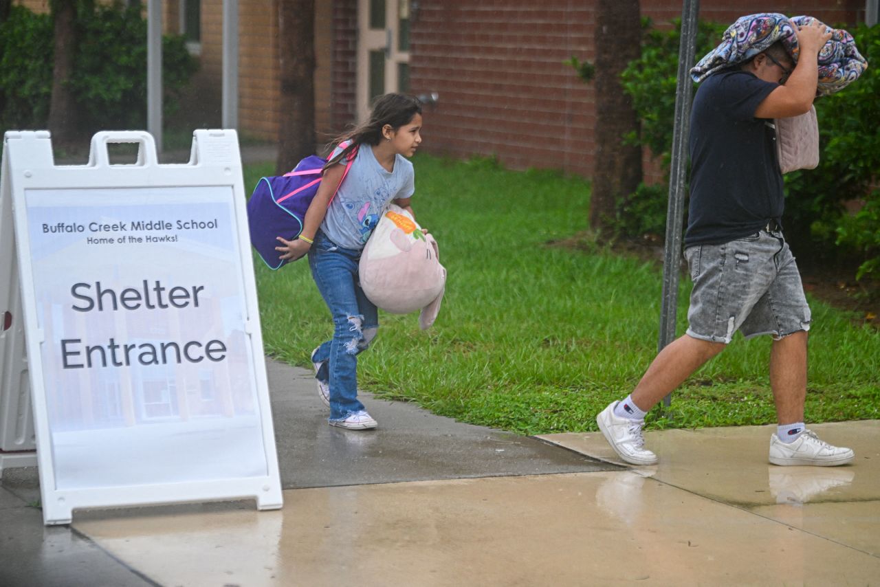 People arrive to shelter at Buffalo Creek Middle School in Bradenton, Florida, on October 9.