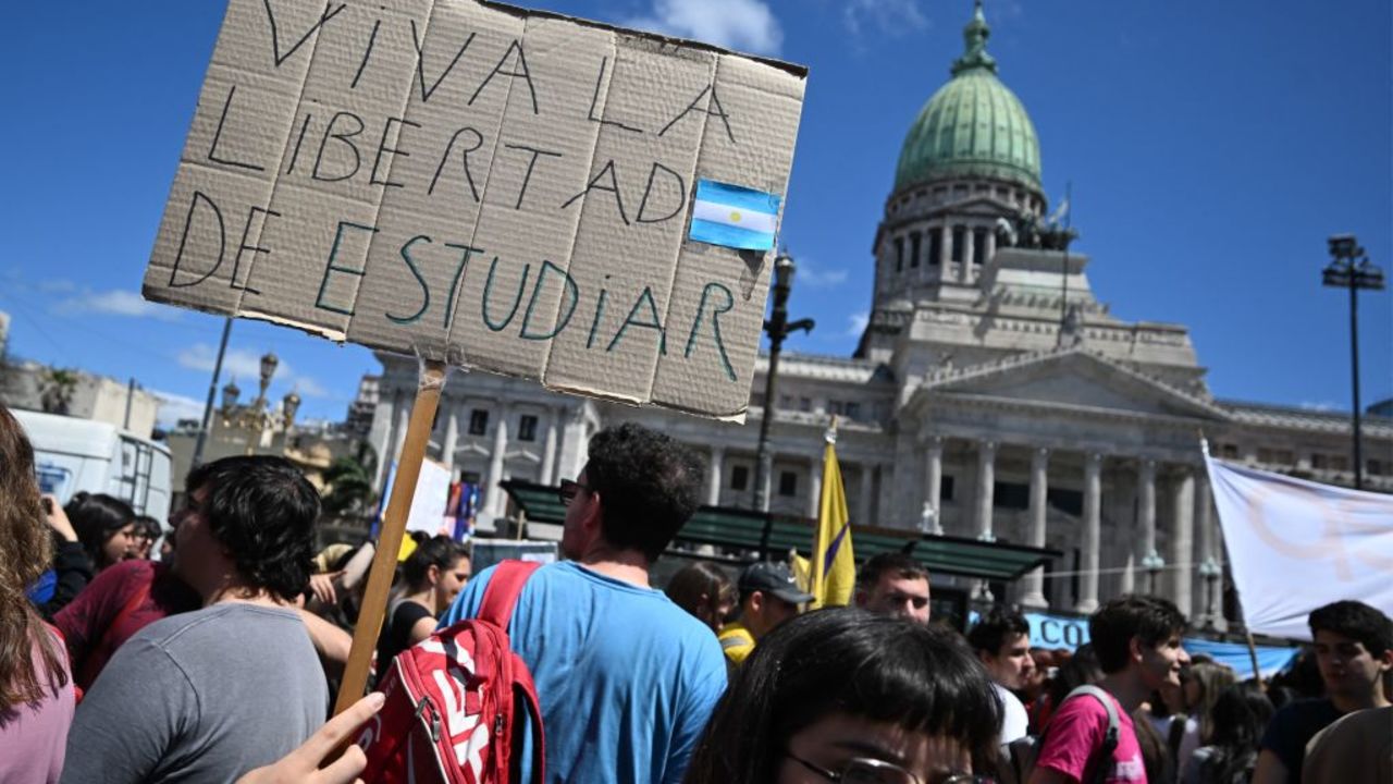 A university student protests holding a sign reading "Long Live the Freedom to Study" outside the Congress while legislators debate Argentina's President Javier Milei's veto of a law that seeks to improve the budget of higher education institutions in Buenos Aires on October 9, 2024. The Chamber of Deputies of the Argentinean Congress will on Wednesday decide on the validity of President Javier Milei's veto of a law that allocates more funds to public universities in a context of student struggle. (Photo by Luis ROBAYO / AFP) (Photo by LUIS ROBAYO/AFP via Getty Images)