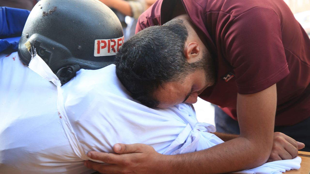 People mourn as they attend funeral ceremony for Al-Aqsa TV cameraman Mohammed al-Tanani, who lost his life during Israeli attack on the Jabalia Refugee Camp, as the body is brought to al-Aqsa Baptist Hospital in Gaza City, Gaza on Wednesday, October 9.