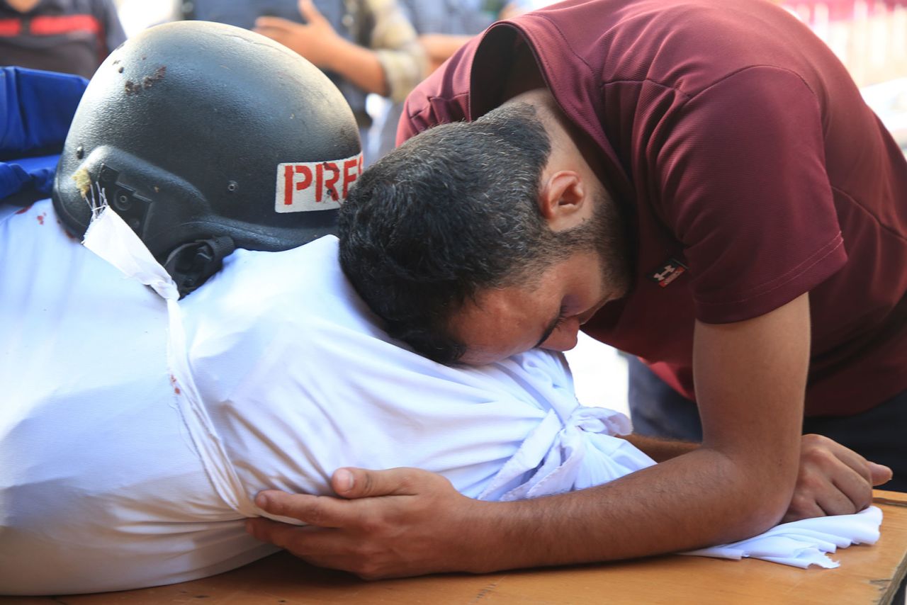 People mourn as they attend funeral ceremony for Al-Aqsa TV cameraman Mohammed al-Tanani, who lost his life during Israeli attack on the Jabalia Refugee Camp, as the body is brought to al-Aqsa Baptist Hospital in Gaza City, Gaza on Wednesday, October 9.