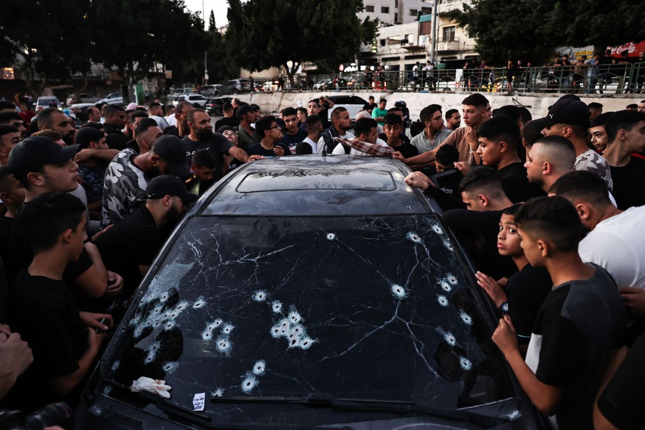 People inspect a bullet-riddled car in Nablus, in the occupied West Bank on Wednesday.