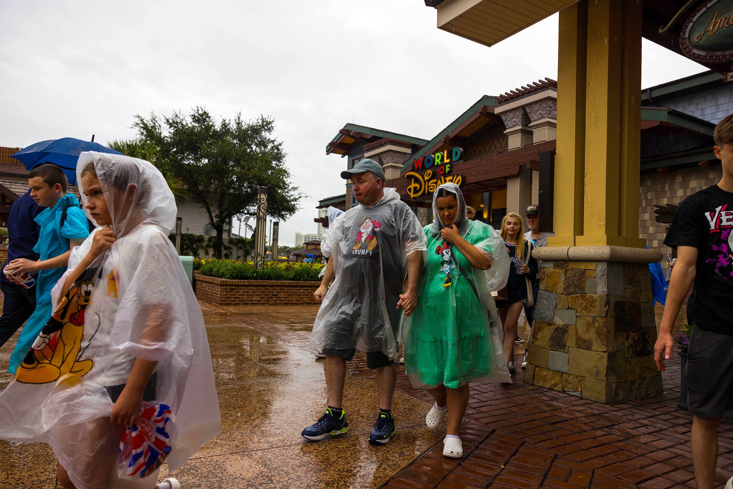 People walk through the Disney Springs shopping complex in Orlando ahead of the hurricane's arrival on Wednesday.