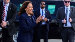 Vice President Kamala Harris greets Democratic volunteers as she boards Air Force Two at LaGuardia Airport in New York City on October 9, 2024.