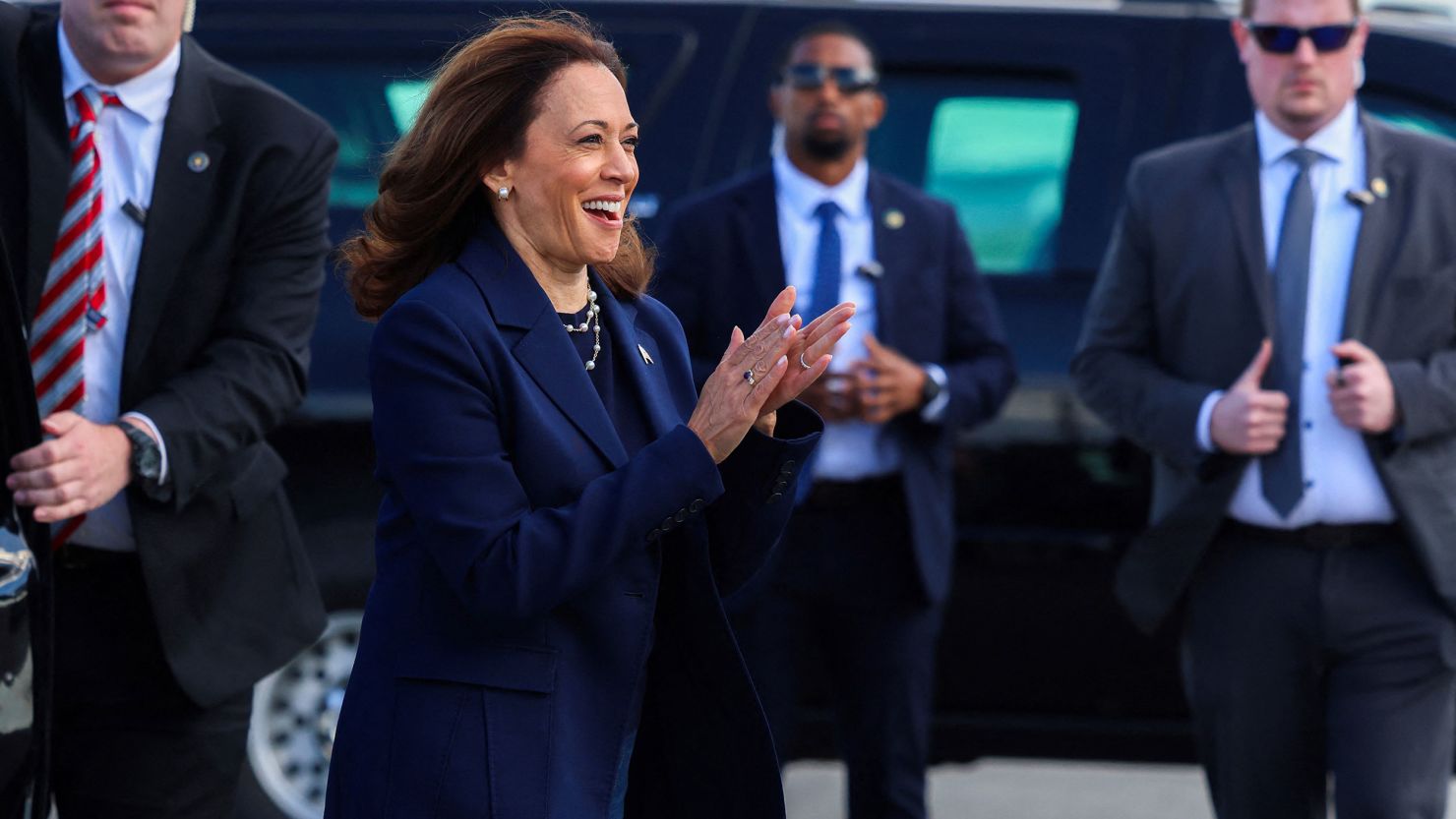 Vice President Kamala Harris greets Democratic volunteers as she boards Air Force Two at LaGuardia Airport in New York City on October 9, 2024.