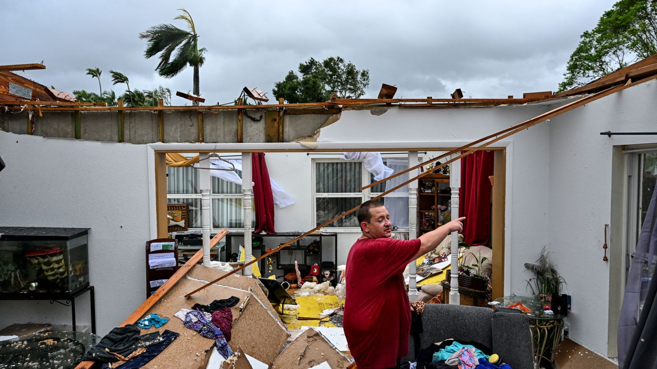 Robert Haight looks around his destroyed house after it was hit by a reported tornado in Fort Myers, Florida, on October 9.