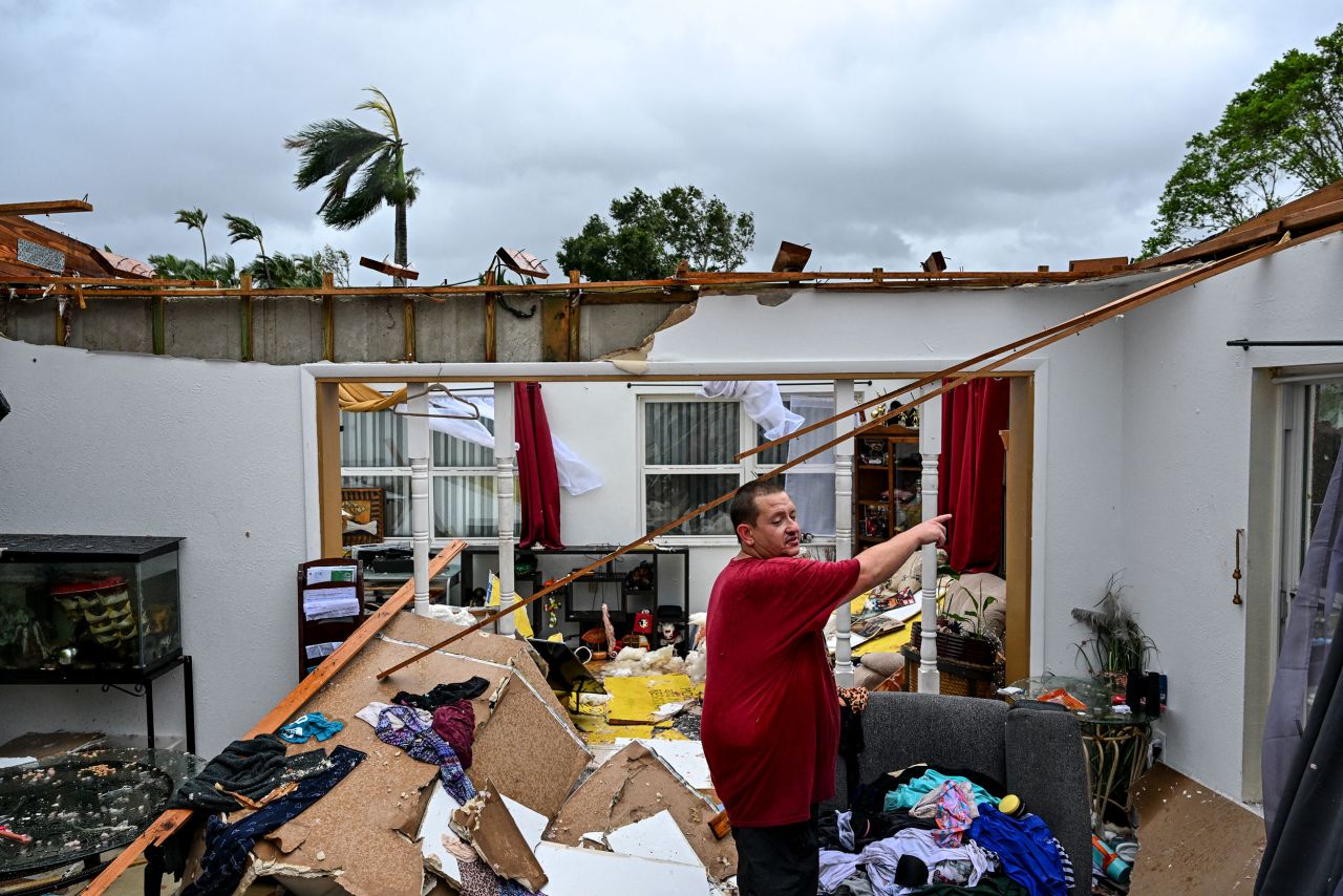 Robert Haight looks around his destroyed house after it was hit by a reported tornado in Fort Myers, Florida, on October 9.