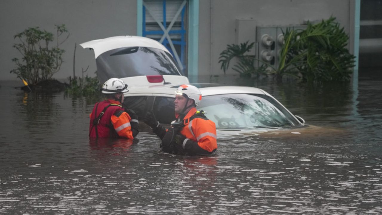 First responders in the water outside an apartment complex that was flooded from and overflowing creek due to Hurricane Milton on October 10, 2024 in Clearwater, Florida. At least four people were confirmed killed as a result of two tornadoes triggered by Hurricane Milton on the east coast of the US state of Florida, local authorities said Thursday. (Photo by Bryan R. SMITH / AFP) (Photo by BRYAN R. SMITH/AFP via Getty Images)