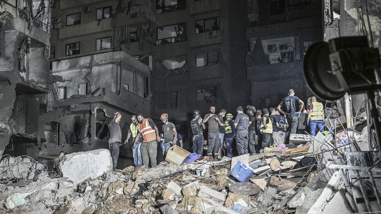 Lebanese civil defense and emergency teams conduct a search and rescue operation following the Israeli airstrike in Beirut on Thursday, October 10.