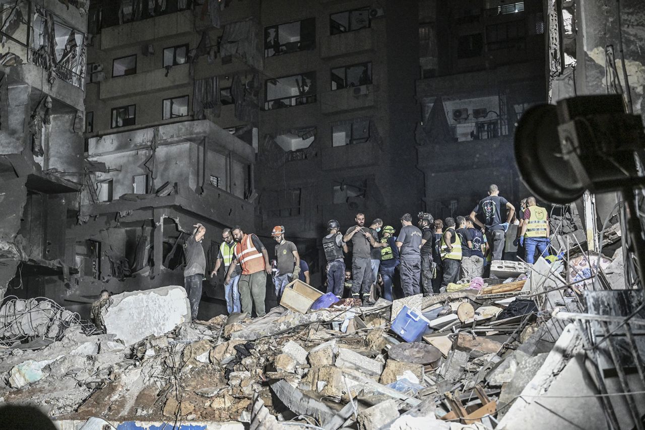 Lebanese civil defense and emergency teams conduct a search and rescue operation following the Israeli airstrike in Beirut on Thursday, October 10.