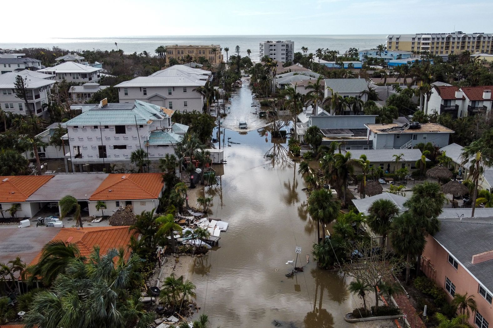 A vehicle drives though a flooded street in Siesta Key on Thursday.