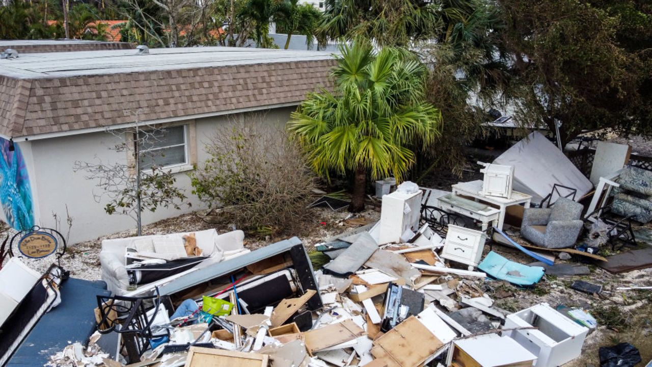 Debris litters a street in the aftermath of Hurricane Milton, in Siesta Key, Florida, on October 10, 2024. At least 10 people were dead after Hurricane Milton smashed into Florida, US authorities said October 10, 2024, after the monster weather system sent tornados spinning across the state and flooded swaths of the Tampa Bay area. (Photo by CHANDAN KHANNA / AFP) (Photo by CHANDAN KHANNA/AFP via Getty Images)