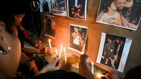Cubans light candles next to pictures of late reggaeton singer Jose Manuel Carbajal 'El Taiger' as they pay tribute in Havana on October 10, 2024. Cuban musician José Manuel Carvajal, known as El Taiger, died Thursday in Miami at the age of 37, after a week hospitalized in critical condition due to a gunshot wound to the head, the Cuban Music Institute and relatives of the singer reported. (Photo by YAMIL LAGE / AFP) (Photo by YAMIL LAGE/AFP via Getty Images)