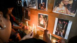 Cubans light candles next to pictures of late reggaeton singer Jose Manuel Carbajal 'El Taiger' as they pay tribute in Havana on October 10, 2024. Cuban musician José Manuel Carvajal, known as El Taiger, died Thursday in Miami at the age of 37, after a week hospitalized in critical condition due to a gunshot wound to the head, the Cuban Music Institute and relatives of the singer reported. (Photo by YAMIL LAGE / AFP) (Photo by YAMIL LAGE/AFP via Getty Images)