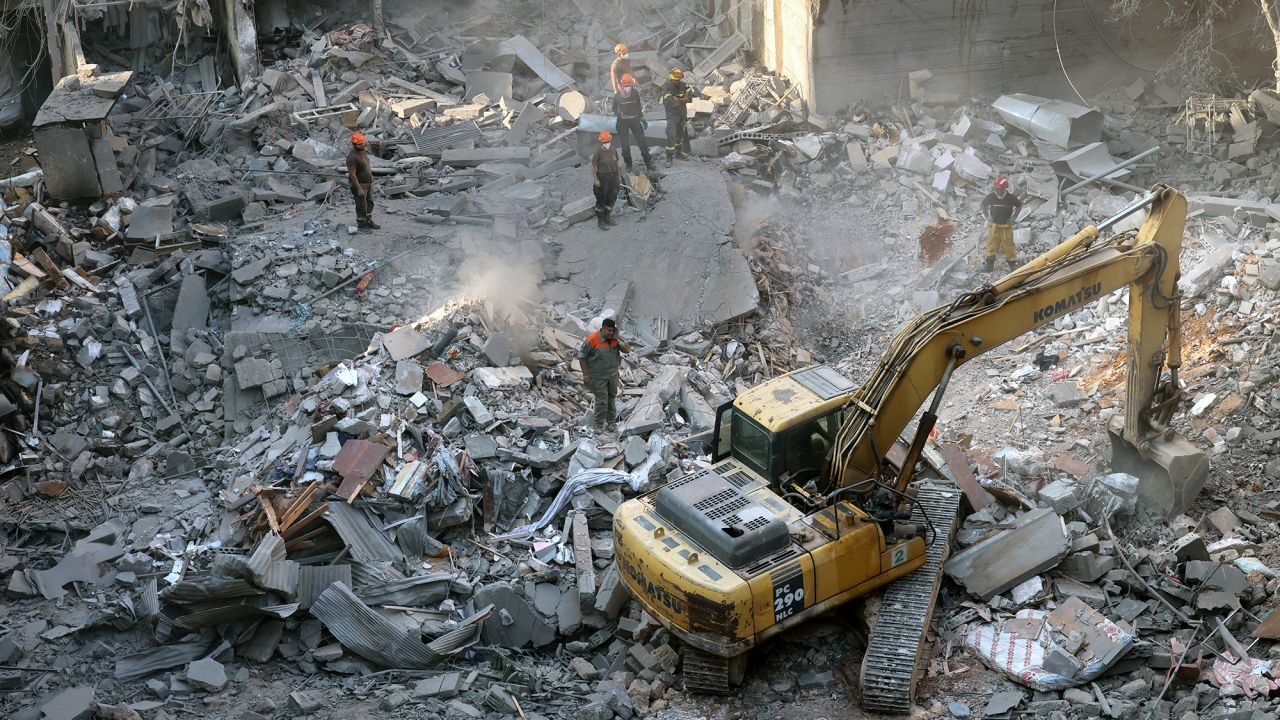 Lebanese civil defense workers at the site of an Israeli airstrike in Beirut, Lebanon, on October 11.