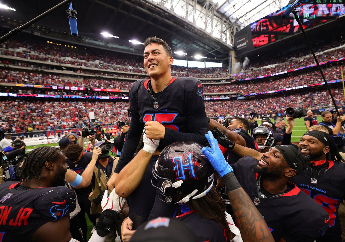 Fairbairn is lifted up by teammates after kicking the winning field goal against the Bills.