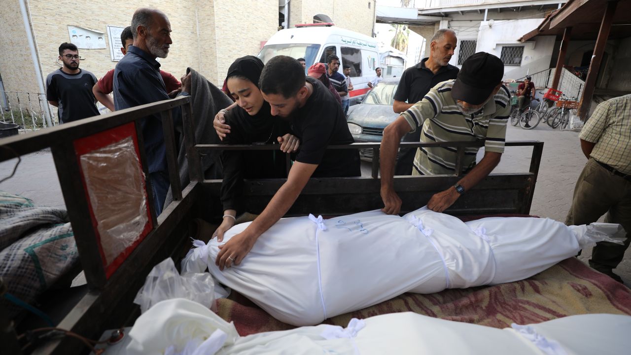 Palestinians mourn over the bodies of those who lost their lives in an Israeli attack on the Jabalya Refugee Camp in Gaza City on October 11.