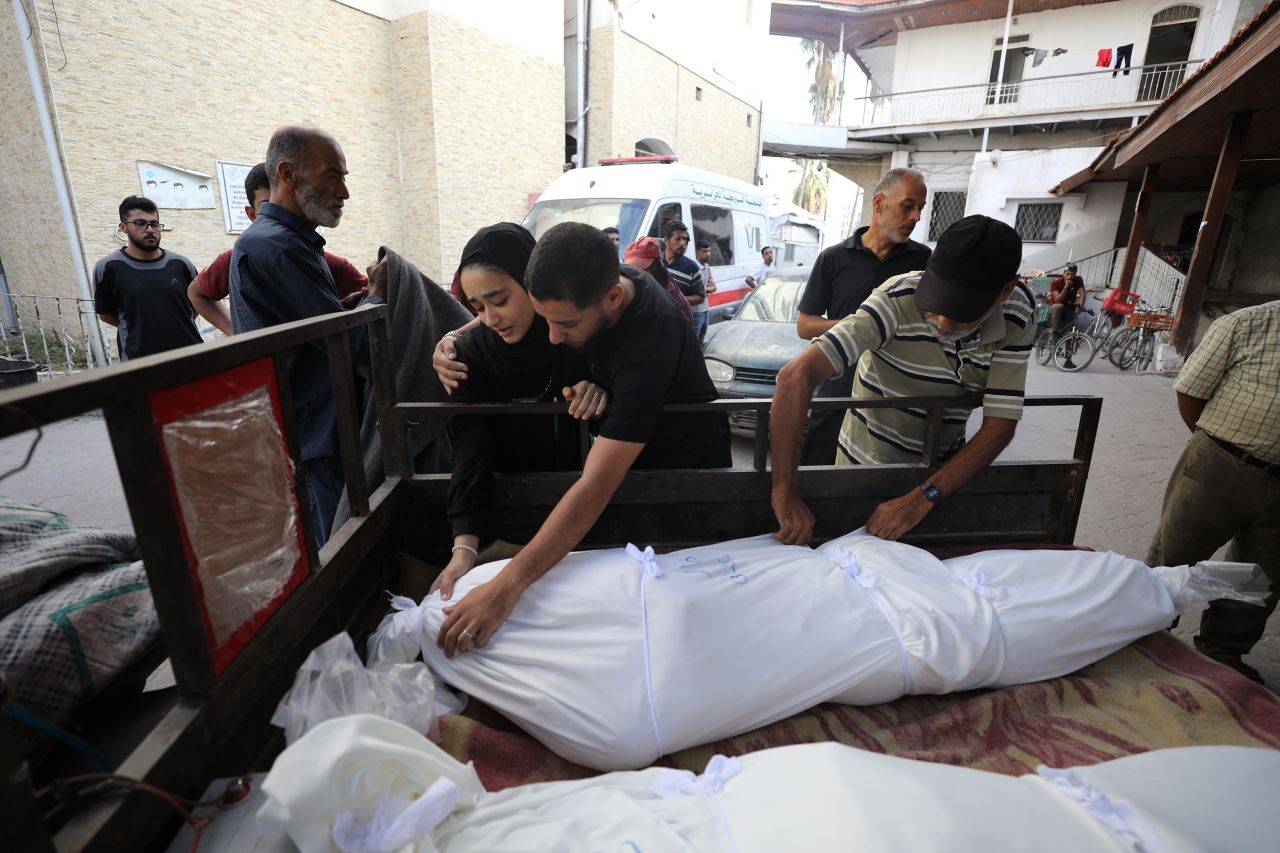 Palestinians mourn over the bodies of those who lost their lives in an Israeli attack on the Jabalya Refugee Camp in Gaza City on October 11.