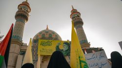 Iranians hold Hezbollah flags during an anti-Israel rally in Tehran, on October 8, 2024. Iran warned Israel on October 8 against attacking any of its infrastructure amid fears of a possible Israeli assault on oil or nuclear sites following Iran's missile barrage last week. Tehran says its attack on Israel, when some 200 missiles were fired, was a response to the death in a Beirut air strike of Hassan Nasrallah, leader of the Iran-backed Lebanese movement Hezbollah, and of Hamas political leader Ismail Haniyeh in Tehran. (Photo by Hossein Beris / Middle East Images / Middle East Images via AFP) (Photo by HOSSEIN BERIS/Middle East Images/AFP via Getty Images)