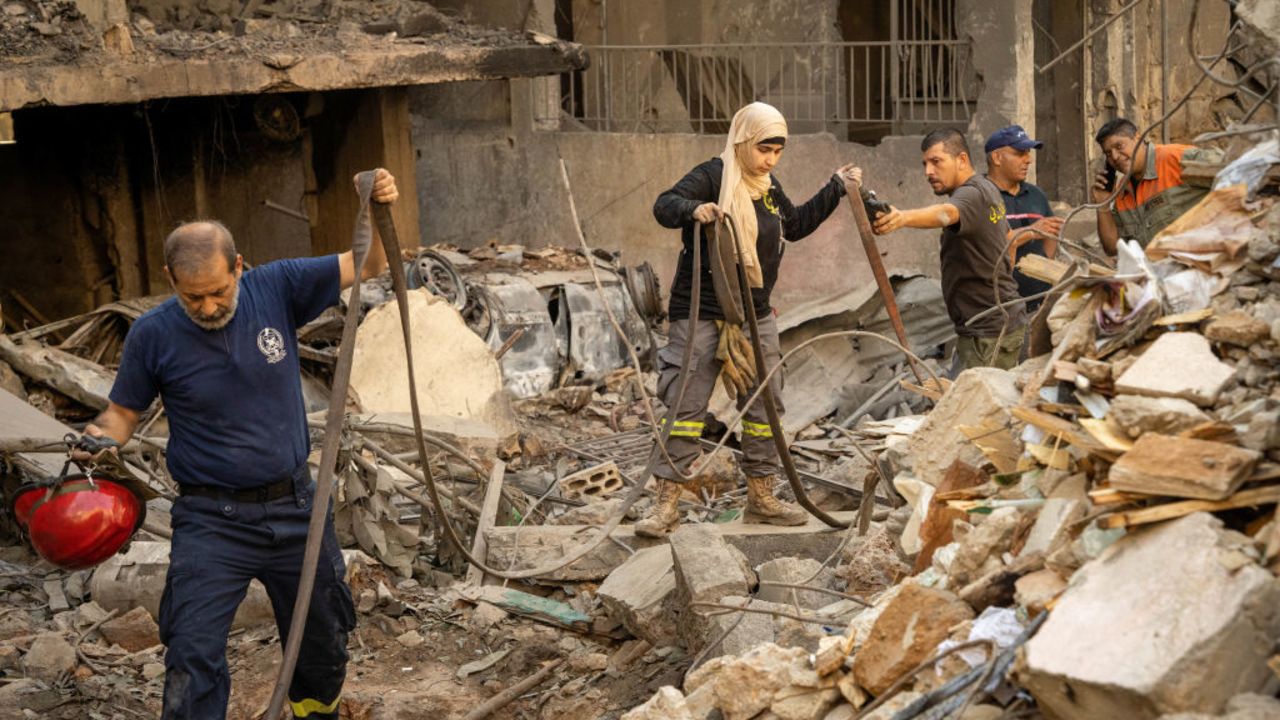 Members of the Civil Defense helping in the search of survivors under the rubble of the building targeted by an israeli airstrike in the Basta neighborhood, Central Beirut. It is one of the few israeli airstrike in the Lebanese Capital itself. October 11 2024. (Photo by Nael Chahine / Middle East Images / Middle East Images via AFP) (Photo by NAEL CHAHINE/Middle East Images/AFP via Getty Images)