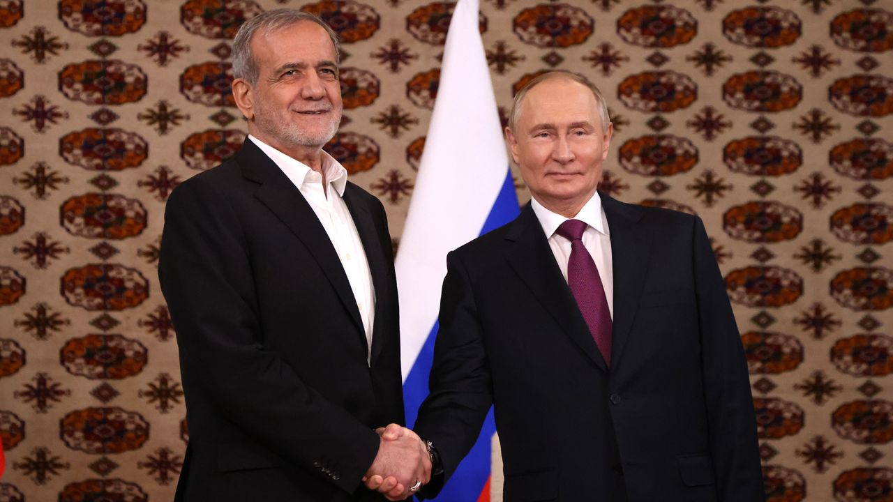 Russian President Vladimir Putin, right, shakes hands with Iranian President Masoud Pezeshkian during their meeting on October 11, in Ashgabat, Turkmenistan.