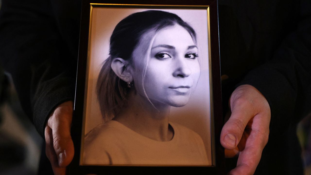 A colleague of Ukrainian journalist Victoria Roshchyna holds a photograph of her during a memorial event in Kyiv.