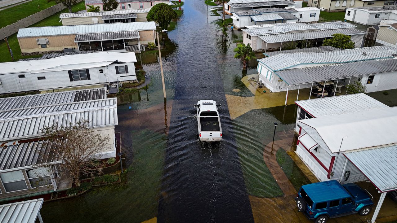 A truck drives through a flooded street in South Daytona, Florida, on Friday.