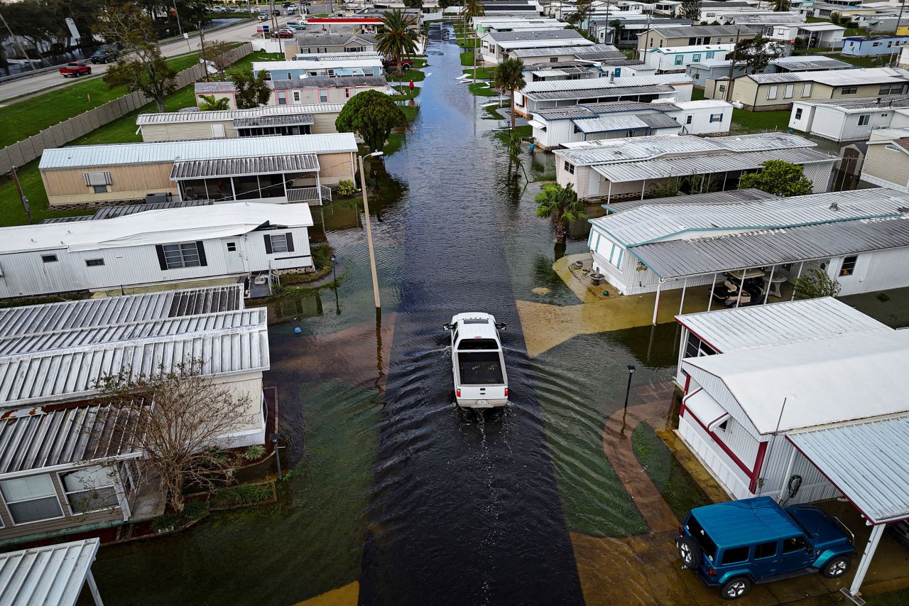 A truck drives through a flooded street in South Daytona, Florida, on Friday.