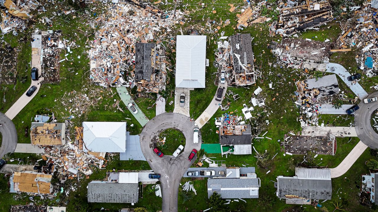 Aerial view of destroyed houses in Port St Lucie, Florida, after a tornado hit the area and caused severe damage as Hurricane Milton swept through Florida on October 11, 2024. The death toll from Hurricane Milton rose to at least 16 on October 11, 2024, officials in Florida said, as residents began the painful process of piecing their lives and homes back together. Nearly 2.5 million households and businesses were still without power, and some areas in the path cut through the Sunshine State by the monster storm from the Gulf of Mexico to the Atlantic Ocean remained flooded. (Photo by Miguel J. Rodriguez Carrillo / AFP) (Photo by MIGUEL J. RODRIGUEZ CARRILLO/AFP via Getty Images)