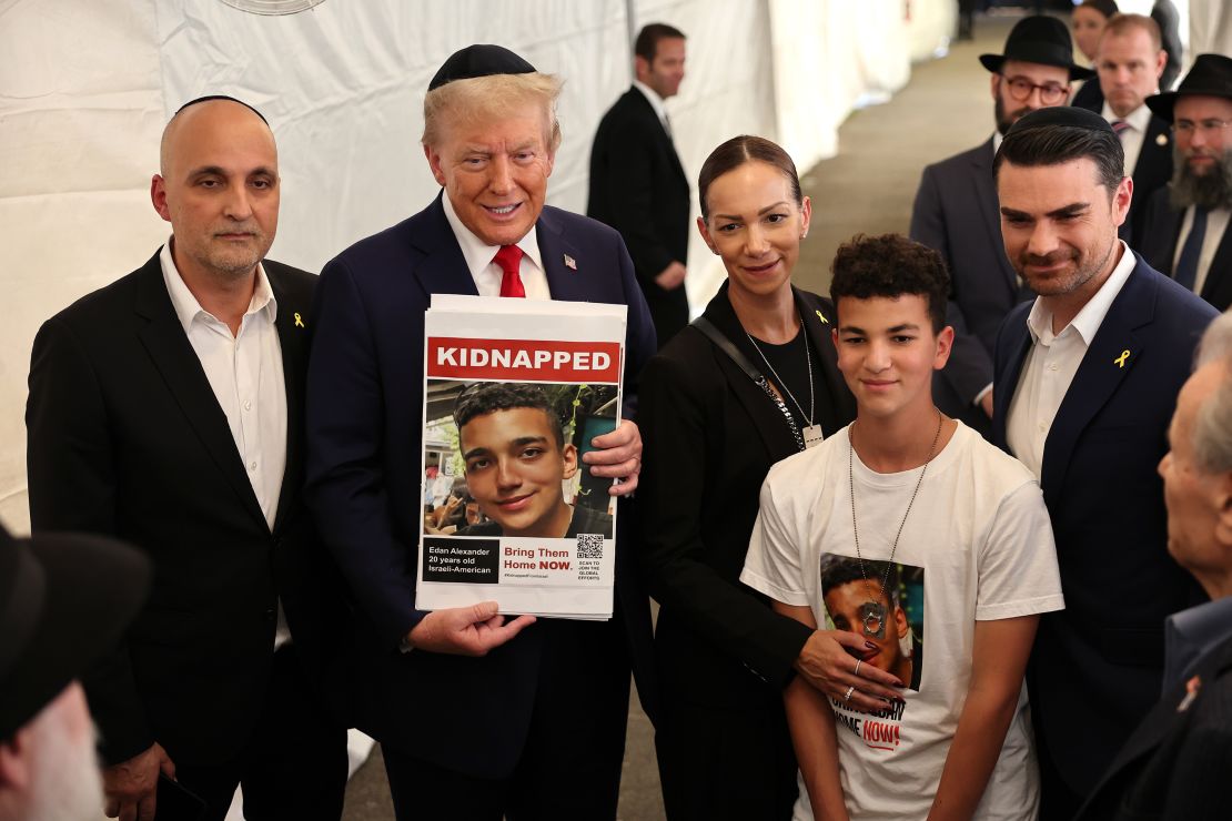 US President Donald Trump poses for photos with the family of Edan Alexander at Ohel Chabad Lubavitch on October 7, 2024 in New York City.