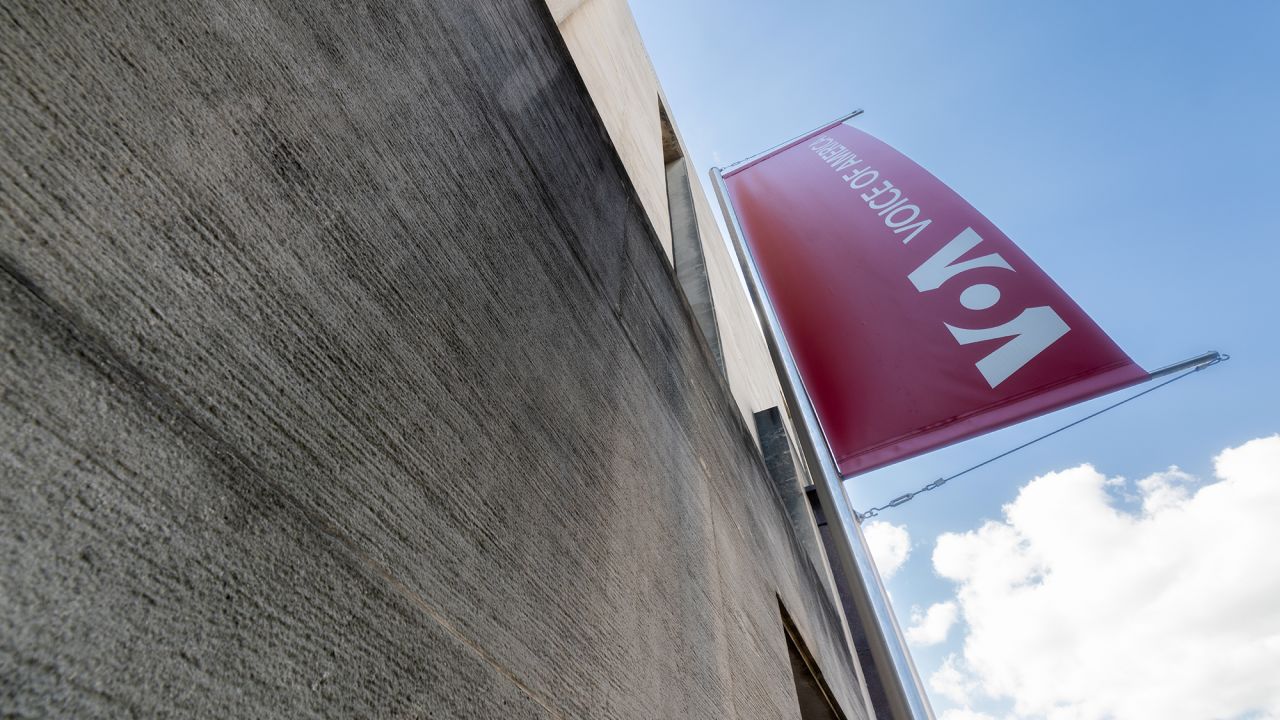 A banner hangs on the side of the Voice of America (VOA) headquarters building in Washington, DC.