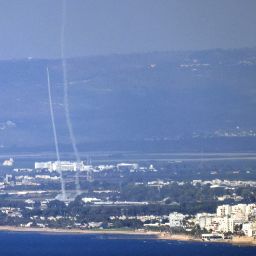 This picture taken from the northern Israeli port city of Haifa shows rockets fired from Israel's Iron Dome air defence system near the northern Israeli city of Acro during a rocket attack from Lebanon on October 12, 2024.