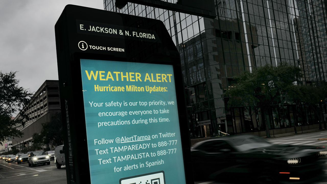 A weather alert is displayed along a sidewalk as Hurricane Milton churns in the Gulf of Mexico, in Tampa, Florida, on October 7.