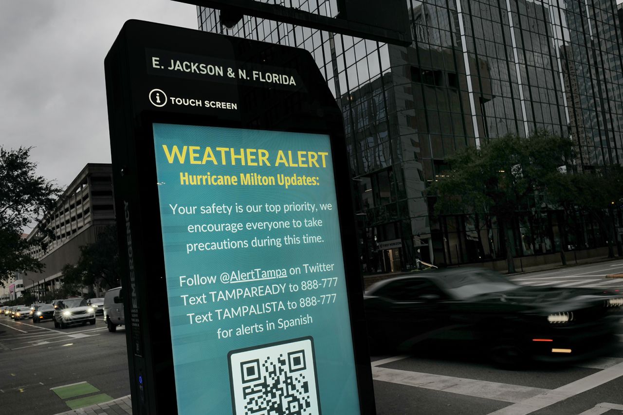 A weather alert is displayed along a sidewalk as Hurricane Milton churns in the Gulf of Mexico, in Tampa, Florida, on October 7.